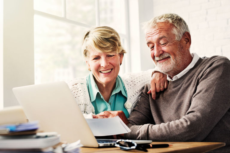 Senior Living Investing Couple on Laptop